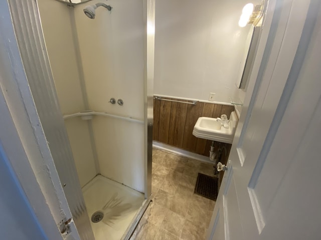 bathroom with a sink and a stall shower