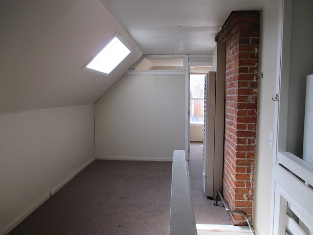 additional living space featuring vaulted ceiling and light carpet