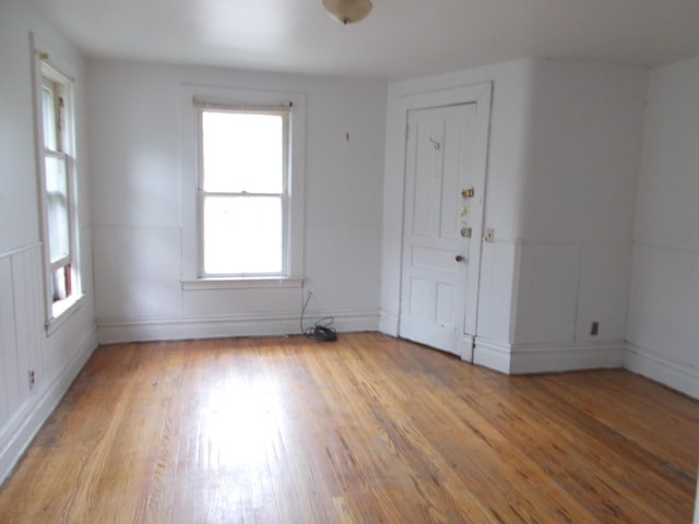 unfurnished room featuring baseboards and light wood-style floors