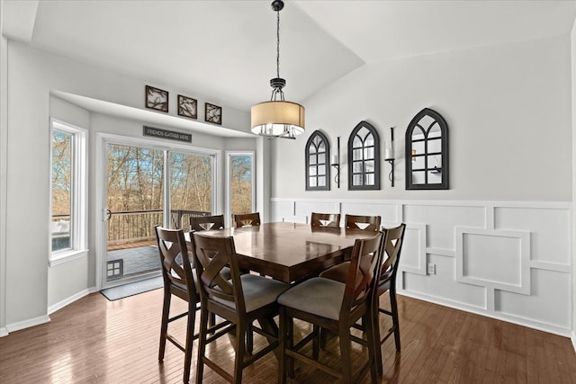 dining space featuring dark wood-style floors and lofted ceiling