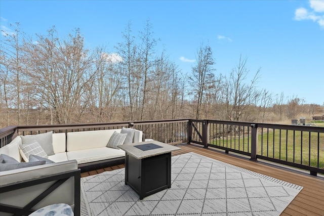 wooden deck with an outdoor living space with a fire pit