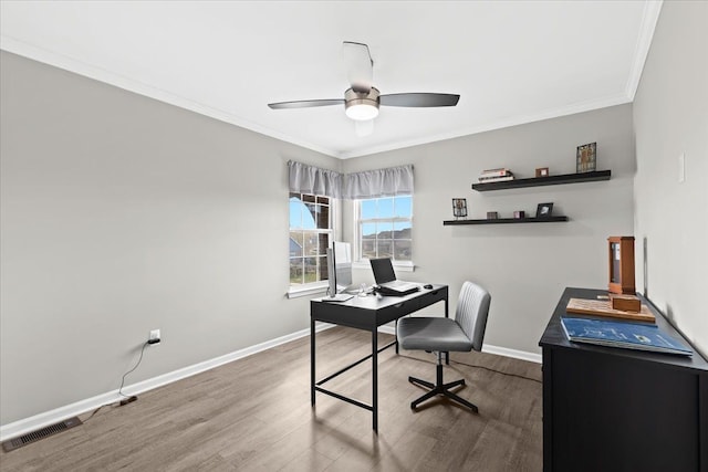 office with ceiling fan, crown molding, visible vents, baseboards, and wood finished floors