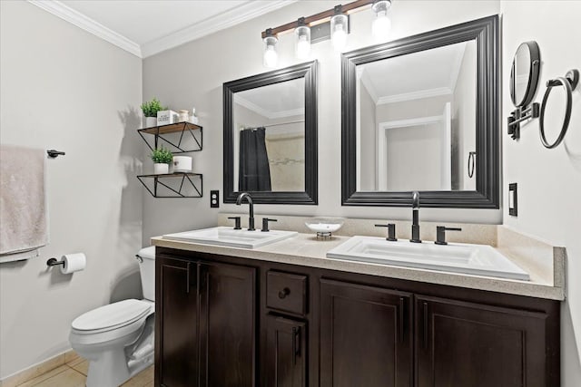 full bath featuring toilet, double vanity, a sink, and tile patterned floors