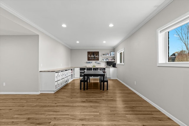 dining area with baseboards, recessed lighting, ornamental molding, and wood finished floors