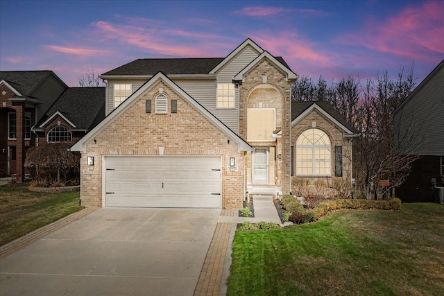 traditional-style home featuring driveway, brick siding, a front lawn, and a garage