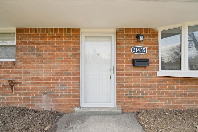 property entrance with brick siding
