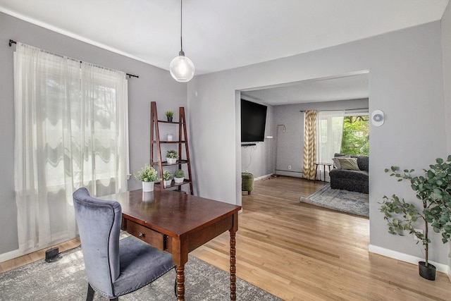 office area featuring light wood-style floors and baseboards