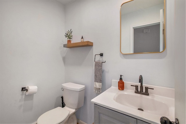 half bathroom featuring toilet and vanity