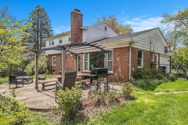 rear view of house with brick siding, a patio area, an outdoor fire pit, a chimney, and fence