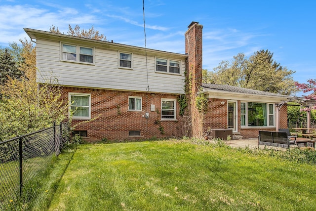 rear view of house featuring a chimney, central air condition unit, brick siding, and a patio