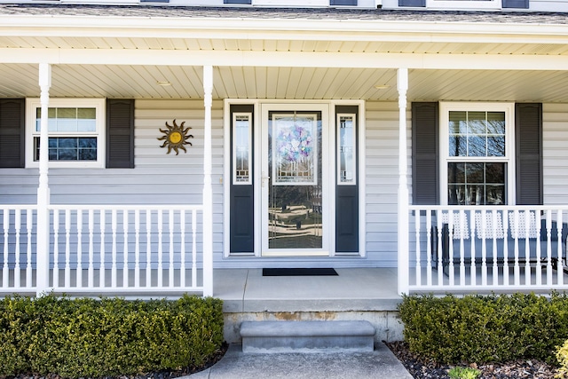 view of exterior entry with a porch