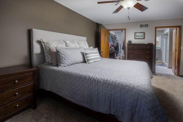 carpeted bedroom with a ceiling fan, visible vents, a spacious closet, and a closet