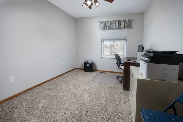 carpeted home office featuring visible vents, a ceiling fan, and baseboards
