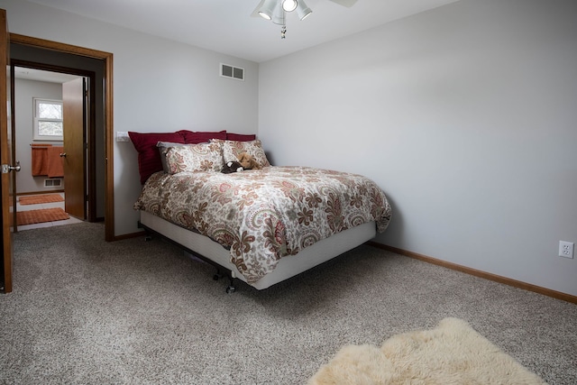 bedroom with baseboards, visible vents, and carpet