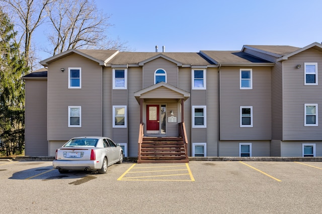 view of property featuring uncovered parking