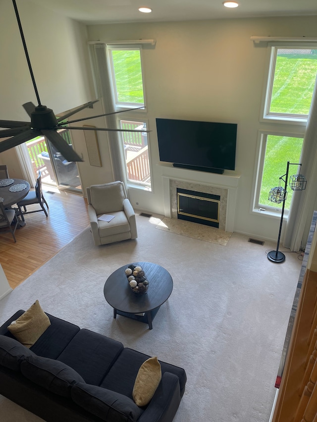 6181 Warwick Dr, Commerce Twp, MI 48382 - carpeted living area featuring healthy amount of natural light, a premium fireplace, a ceiling fan, and recessed lighting
