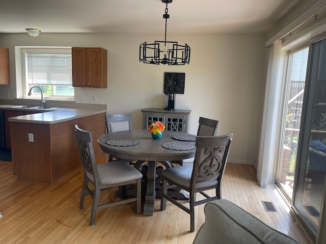 6181 Warwick Dr, Commerce Twp, MI 48382 - dining space with light wood-style floors and a chandelier