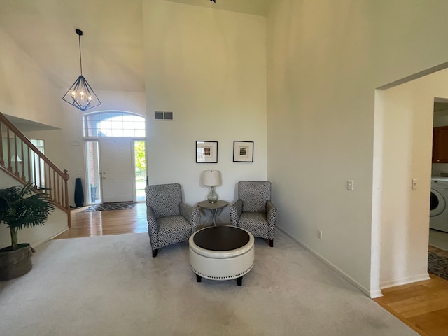 6181 Warwick Dr, Commerce Twp, MI 48382 - foyer with a high ceiling, a chandelier, washer / dryer, stairs, and baseboards