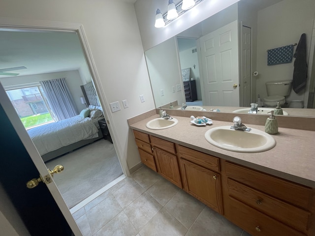 6181 Warwick Dr, Commerce Twp, MI 48382 - full bathroom featuring connected bathroom, toilet, double vanity, tile patterned flooring, and baseboards