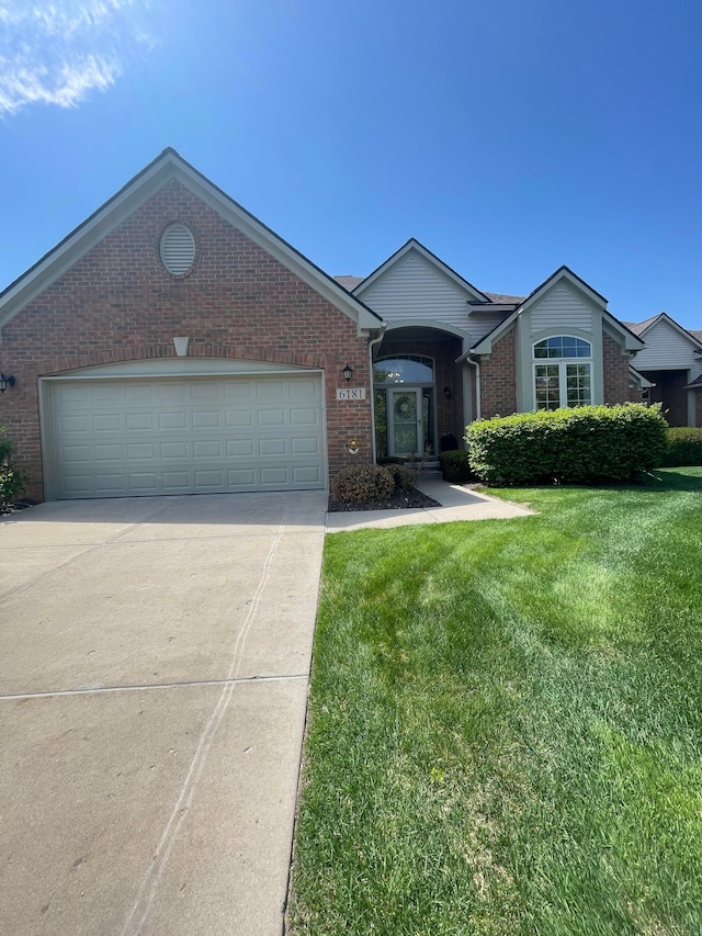 6181 Warwick Dr, Commerce Twp, MI 48382 - single story home with brick siding, concrete driveway, a front lawn, and an attached garage