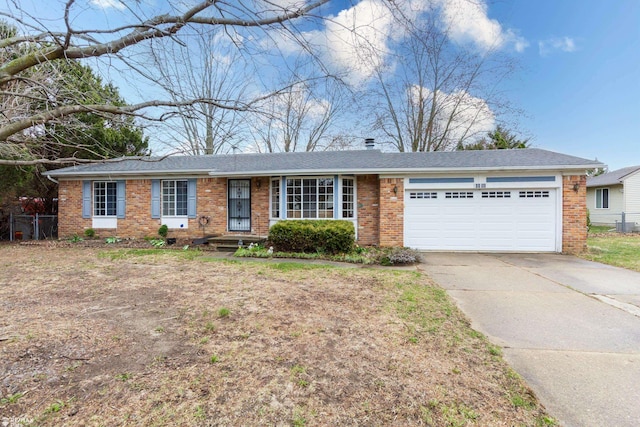 6051 Homestead Pl, Grand Blanc, MI 48439 - ranch-style home featuring a garage, concrete driveway, and brick siding
