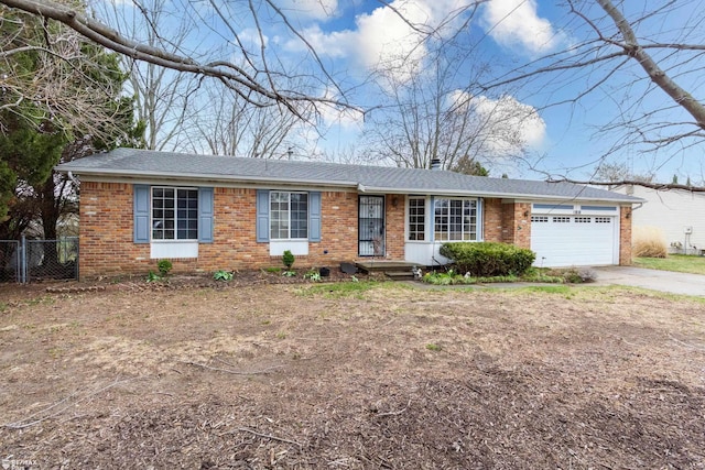6051 Homestead Pl, Grand Blanc, MI 48439 - ranch-style house featuring a garage, fence, driveway, and brick siding