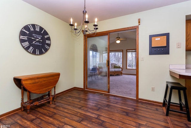 6051 Homestead Pl, Grand Blanc, MI 48439 - dining room featuring ceiling fan with notable chandelier, baseboards, and dark wood-style floors