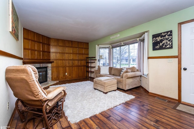 6051 Homestead Pl, Grand Blanc, MI 48439 - living room featuring hardwood / wood-style floors, a brick fireplace, baseboards, and visible vents