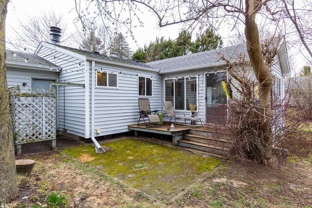 6051 Homestead Pl, Grand Blanc, MI 48439 - back of house with a wooden deck, fence, and a lawn