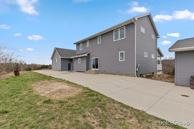 rear view of house with a patio area and a yard