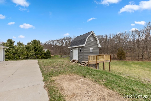 view of yard with an outbuilding and a wooden deck
