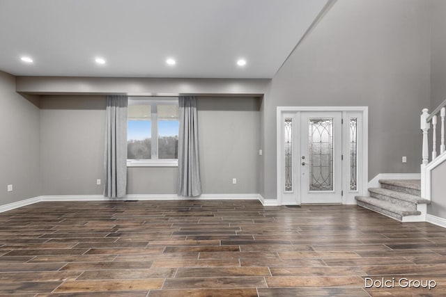 foyer entrance featuring recessed lighting, baseboards, dark wood finished floors, and stairway