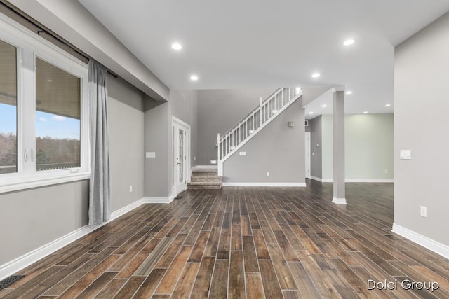 unfurnished living room featuring wood finished floors, baseboards, visible vents, and recessed lighting