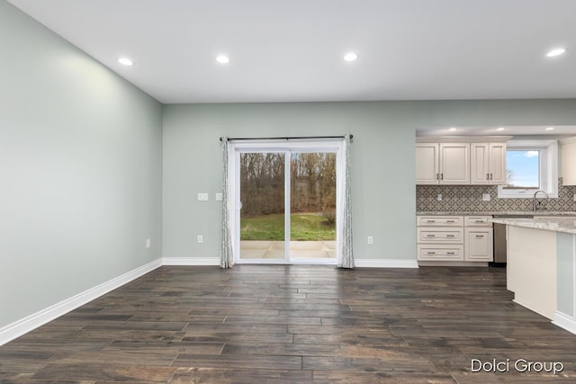 interior space featuring recessed lighting, dark wood-type flooring, and baseboards