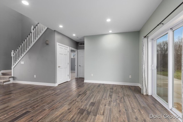 unfurnished living room featuring recessed lighting, stairs, baseboards, and dark wood finished floors