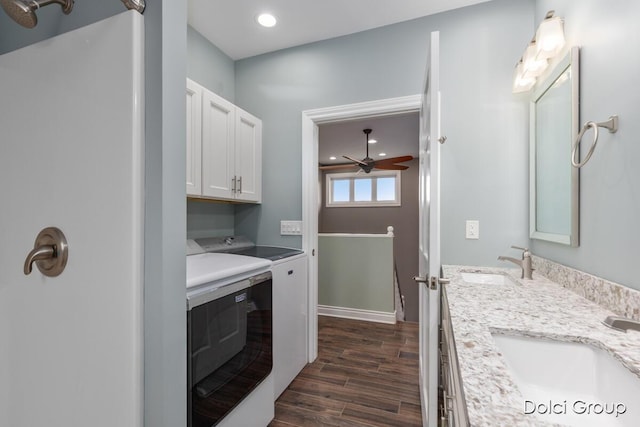 washroom featuring a sink, independent washer and dryer, ceiling fan, and dark wood-style floors