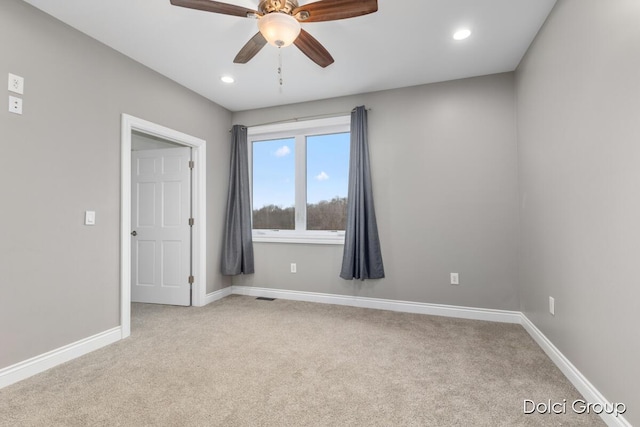 spare room with carpet flooring, baseboards, a ceiling fan, and recessed lighting