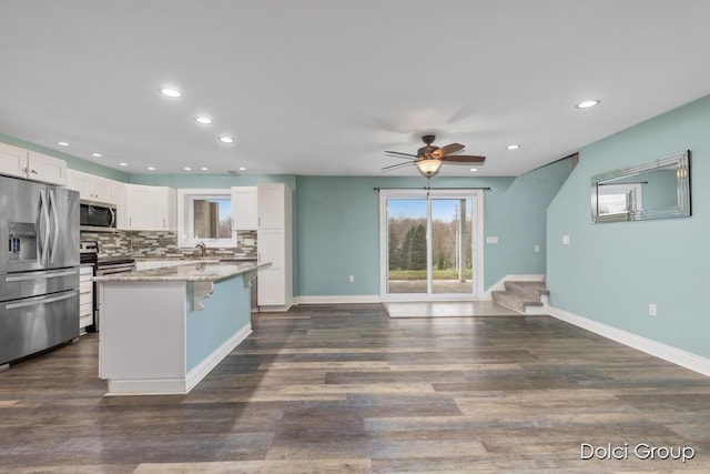 kitchen featuring tasteful backsplash, appliances with stainless steel finishes, a ceiling fan, white cabinetry, and recessed lighting