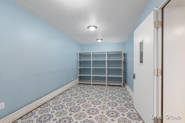 unfurnished room featuring baseboards