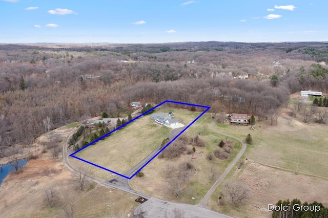 birds eye view of property featuring a view of trees and a rural view