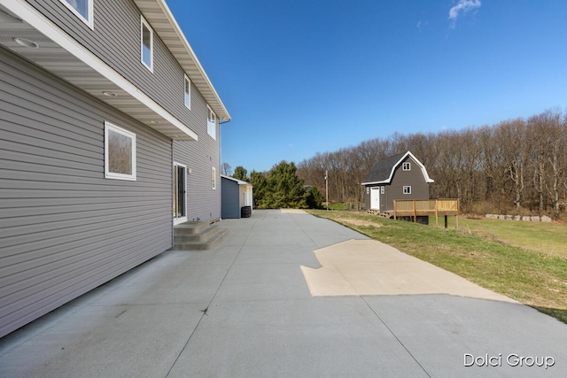 view of home's exterior featuring a view of trees and a yard