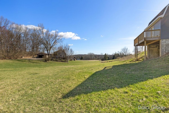view of yard with a rural view and a deck