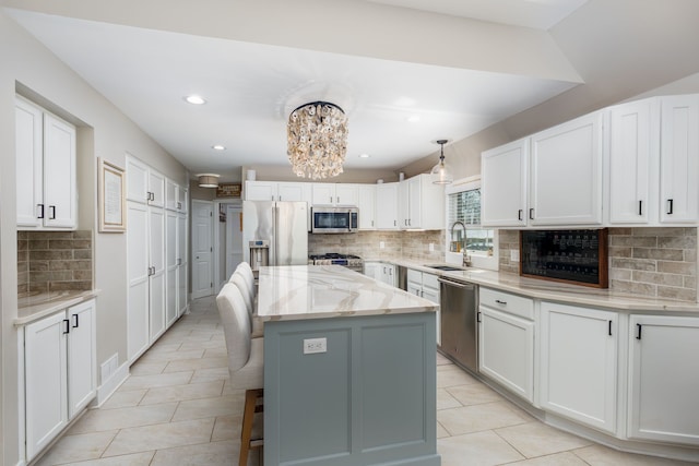 kitchen with stainless steel appliances, decorative backsplash, and light tile patterned flooring