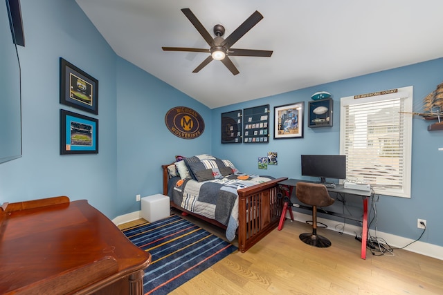 bedroom featuring lofted ceiling, baseboards, wood finished floors, and ceiling fan