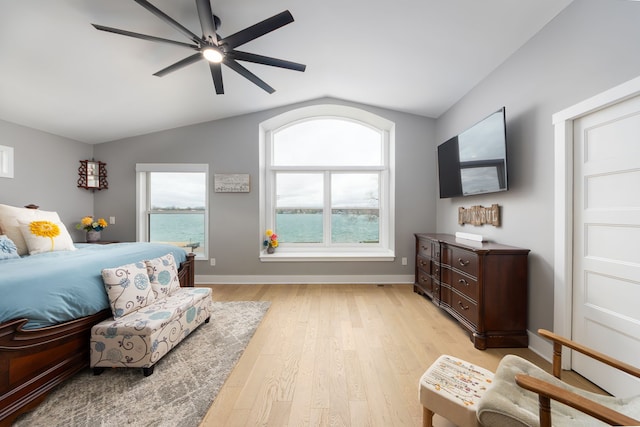 bedroom with lofted ceiling, light wood-style flooring, baseboards, and ceiling fan