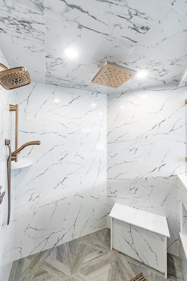 bathroom featuring a marble finish shower