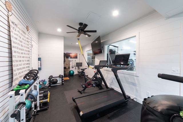workout area featuring wood walls, a ceiling fan, and recessed lighting
