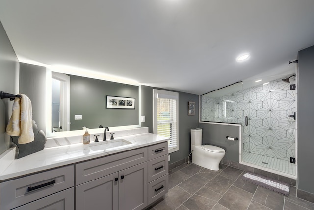 bathroom featuring a stall shower, toilet, baseboards, recessed lighting, and vanity