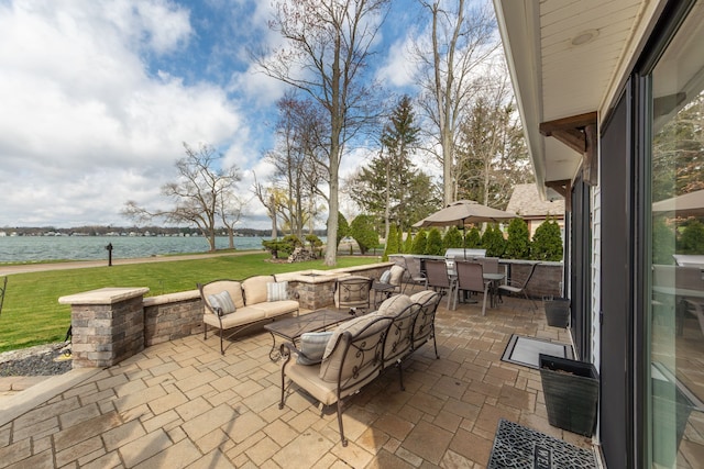 view of patio / terrace featuring outdoor dining space and a water view