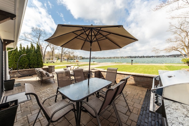 view of patio with outdoor dining space and a water view